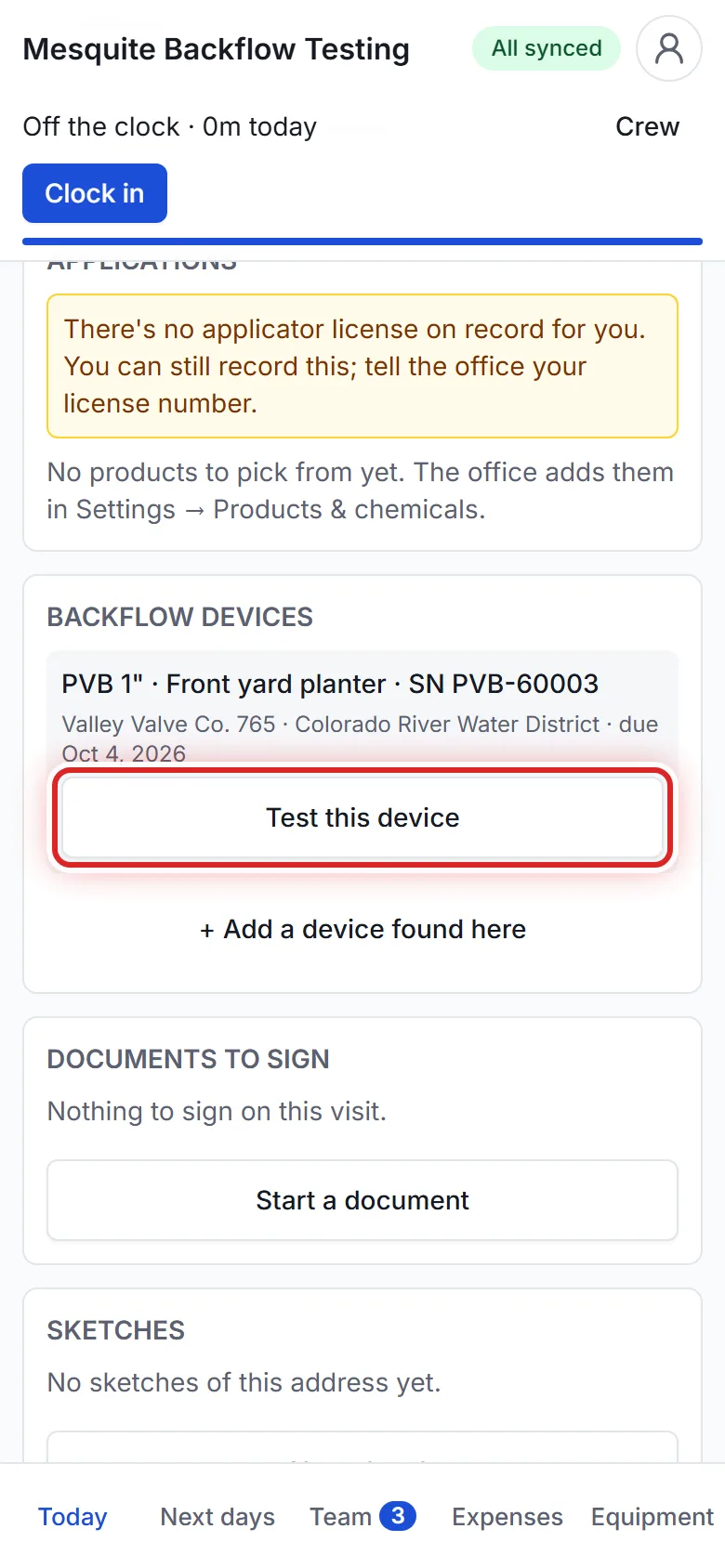 A tester recording a backflow test on a phone.