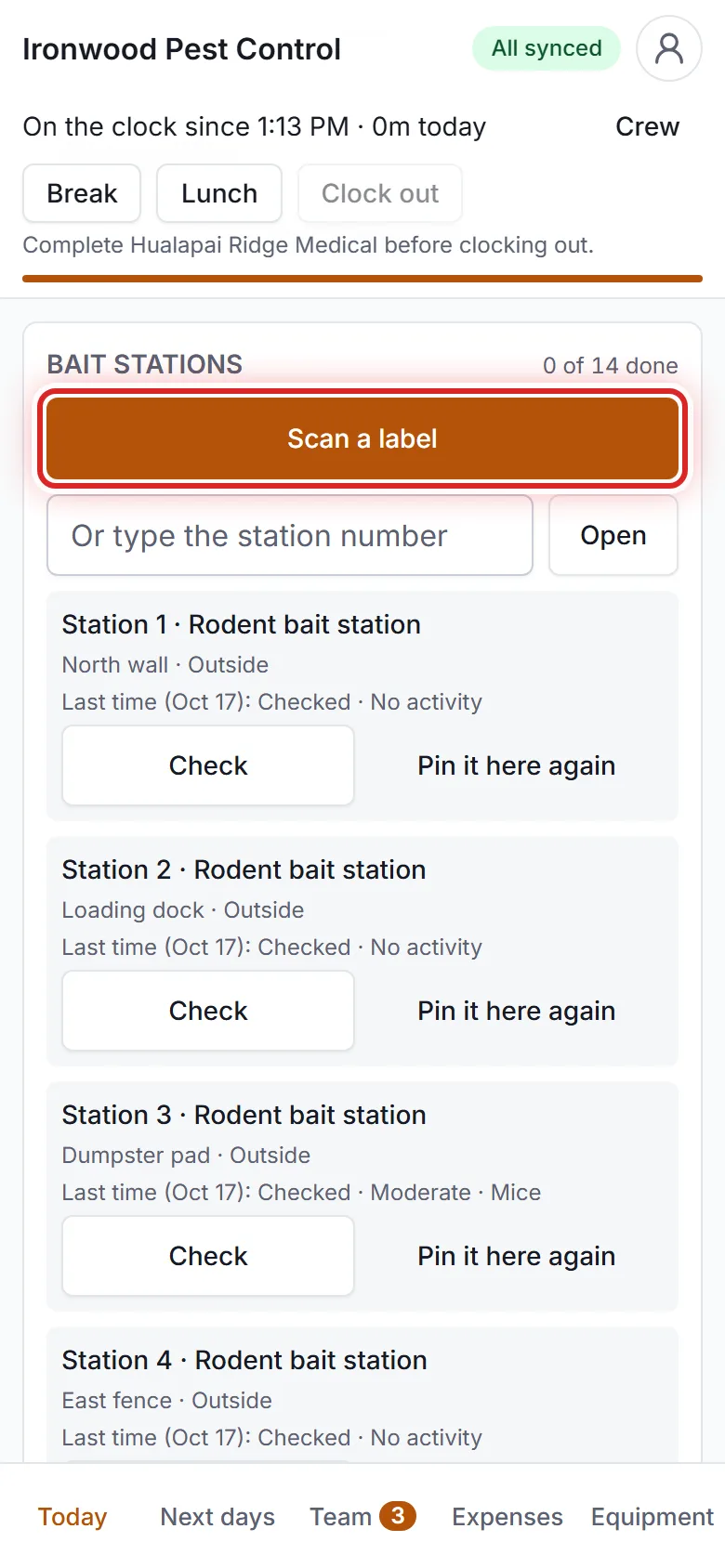 A tech checking bait stations on a phone.